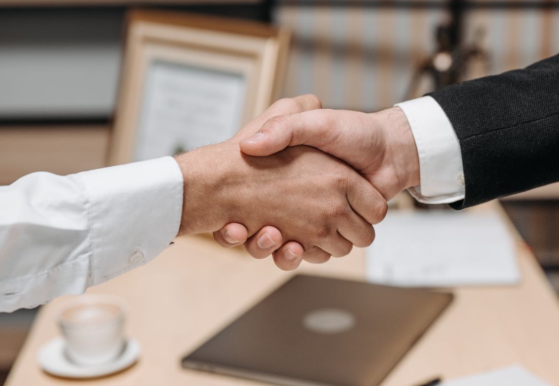 A partnership handshake between institutions